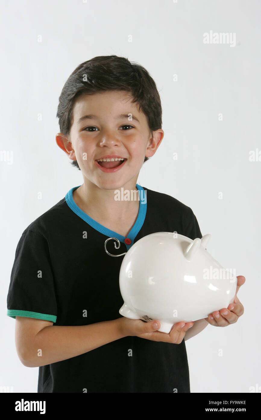 Boy with Piggy Bank les aspirations de l'argent Banque D'Images