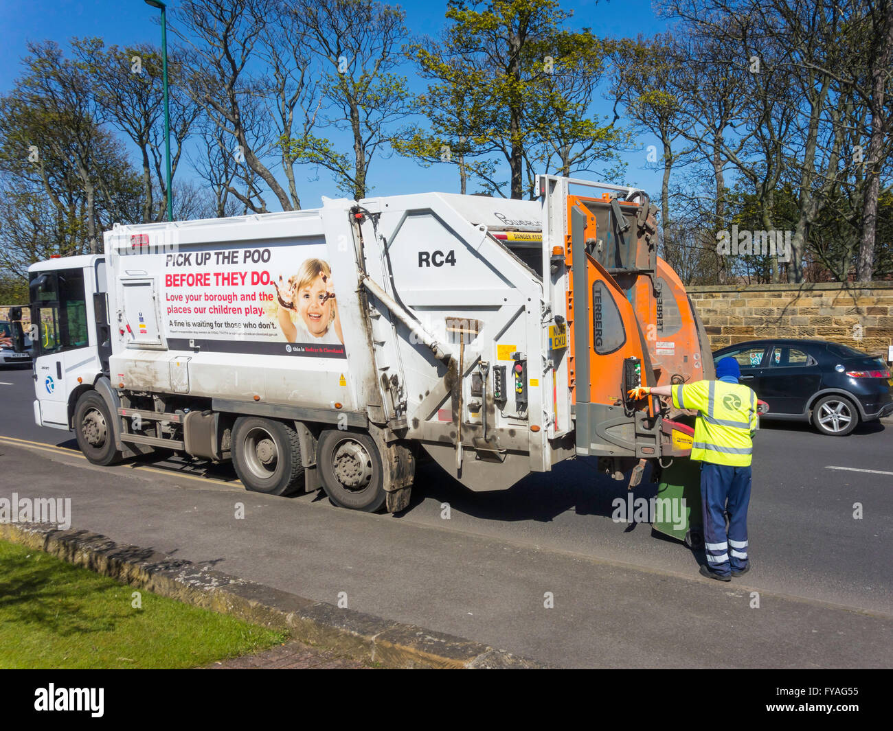 L'homme travaillant à l'arrière d'un véhicule d'élimination des déchets vidange d'un wheelie bin de déchets ménagers pour le recyclage pick up dog poo Banque D'Images