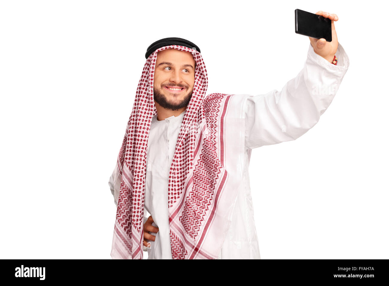 En arabe moderne avec un téléphone cellulaire et selfies smiling isolé sur fond blanc Banque D'Images En arabe moderne avec un téléphone cellulaire et selfies smiling isolé sur fond blanc Banque D'Images