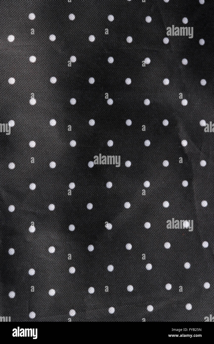 Fond tissu noir à pois blancs Banque D'Images