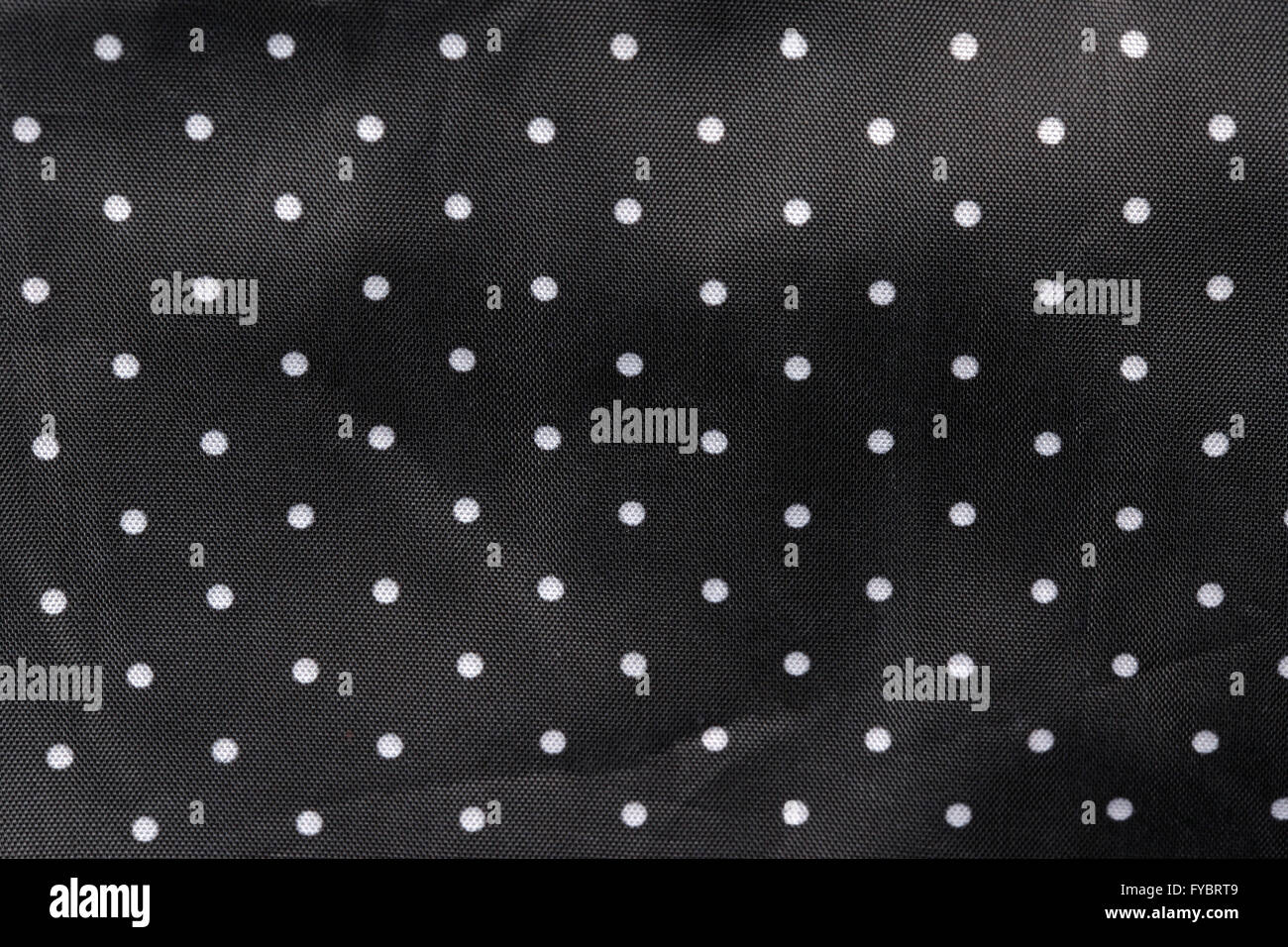 Fond tissu noir à pois blancs Banque D'Images