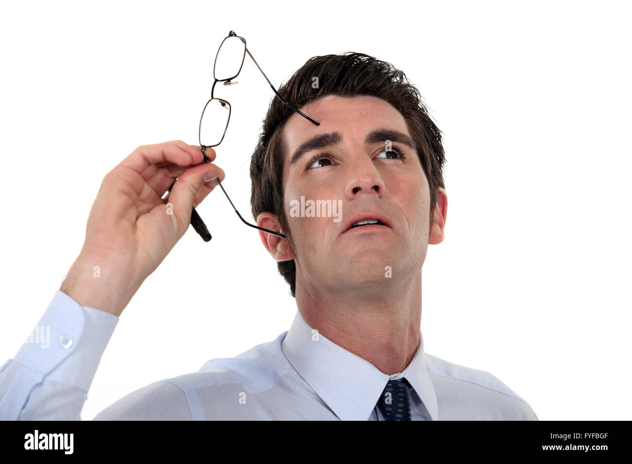 L'homme prenant ses lunettes et regardant vers le haut Banque D'Images