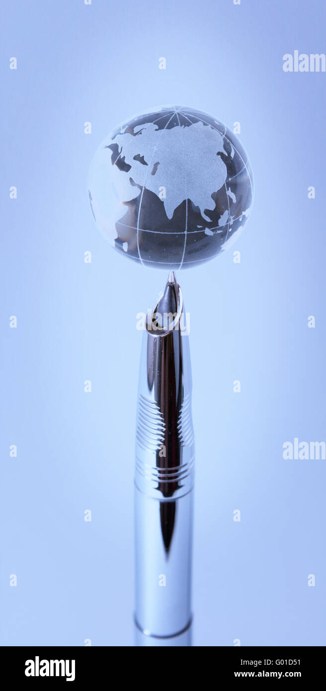 Globe de cristal sur nib de stylo à lumière bleue Photo Stock - Alamy