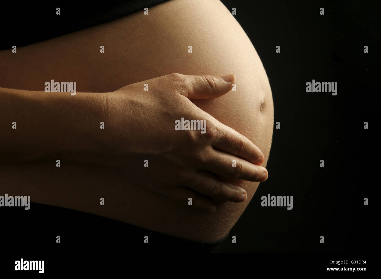 Hand Touching Pregnant Belly Banque D'Images