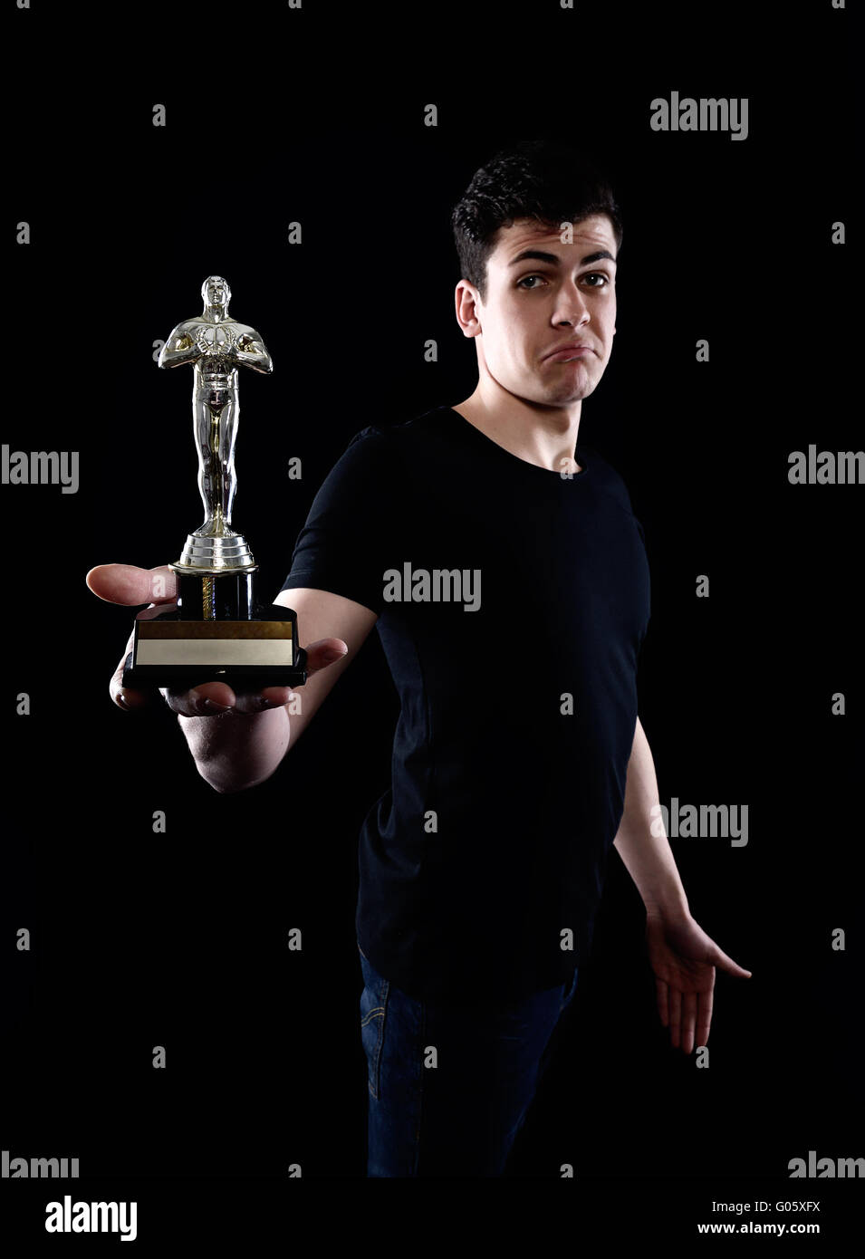 Young man holding fake oscar award Banque D'Images
