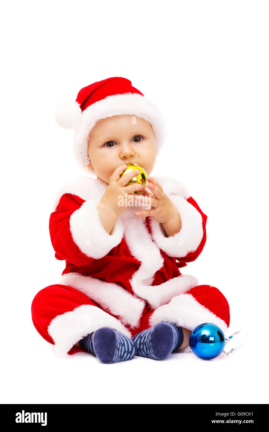 Petit Père Noël avec des jouets et des sphères en mains Banque D'Images