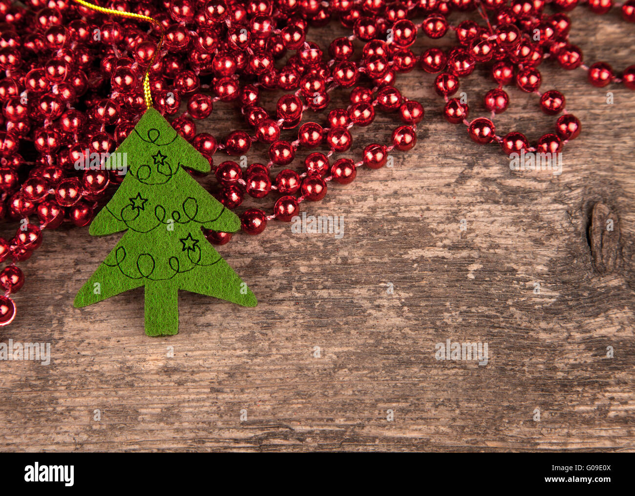 Perles rouges sur le vieux bois avec arbre de Noël Banque D'Images
