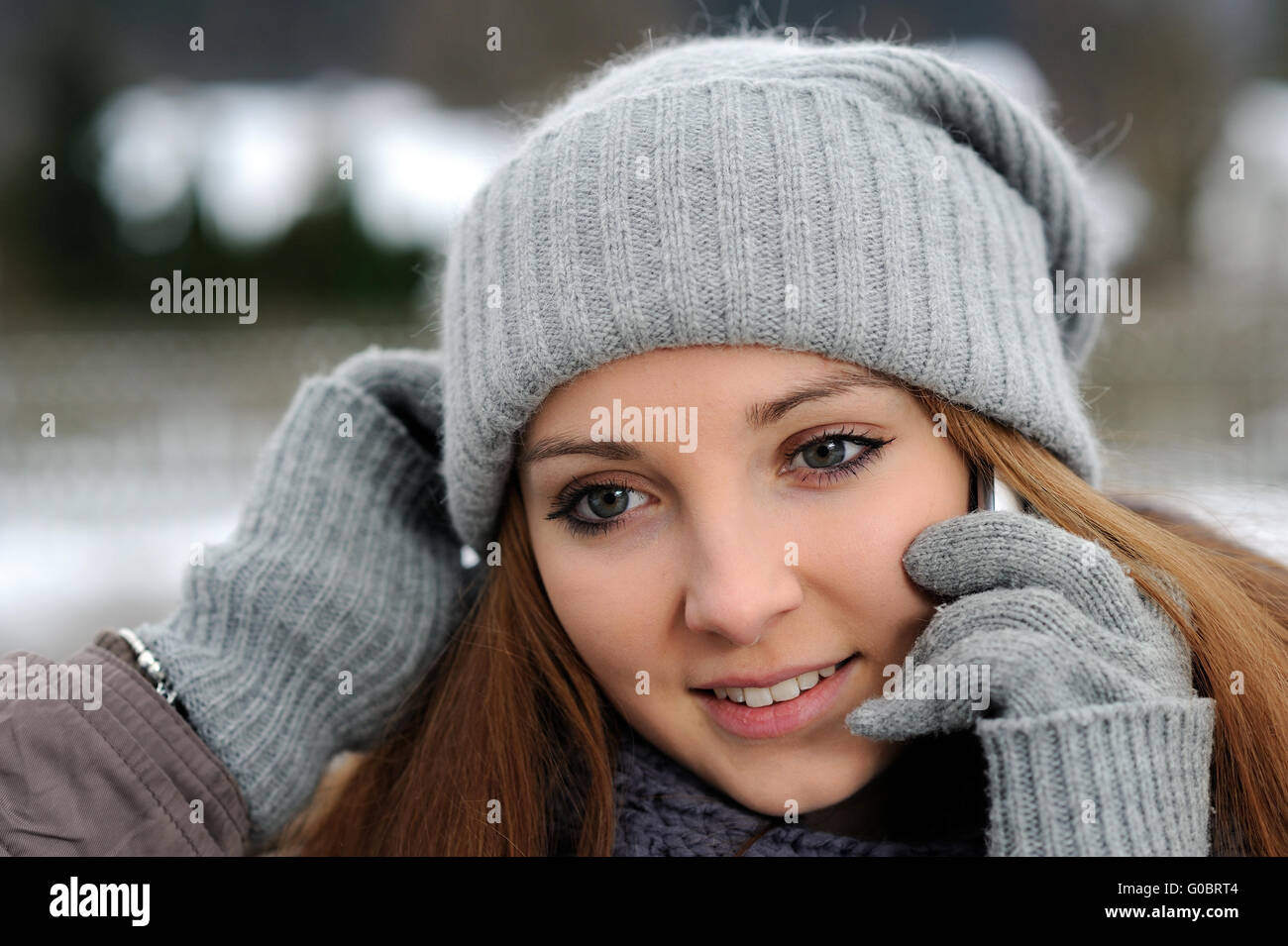 Jeune femme portant des vêtements d'hiver mobile avec Banque D'Images