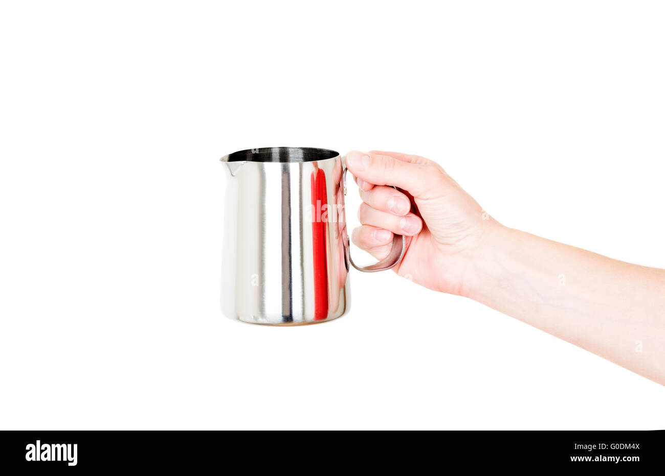 Chaudière en acier inoxydable pot de lait dans la main isolated on white Banque D'Images