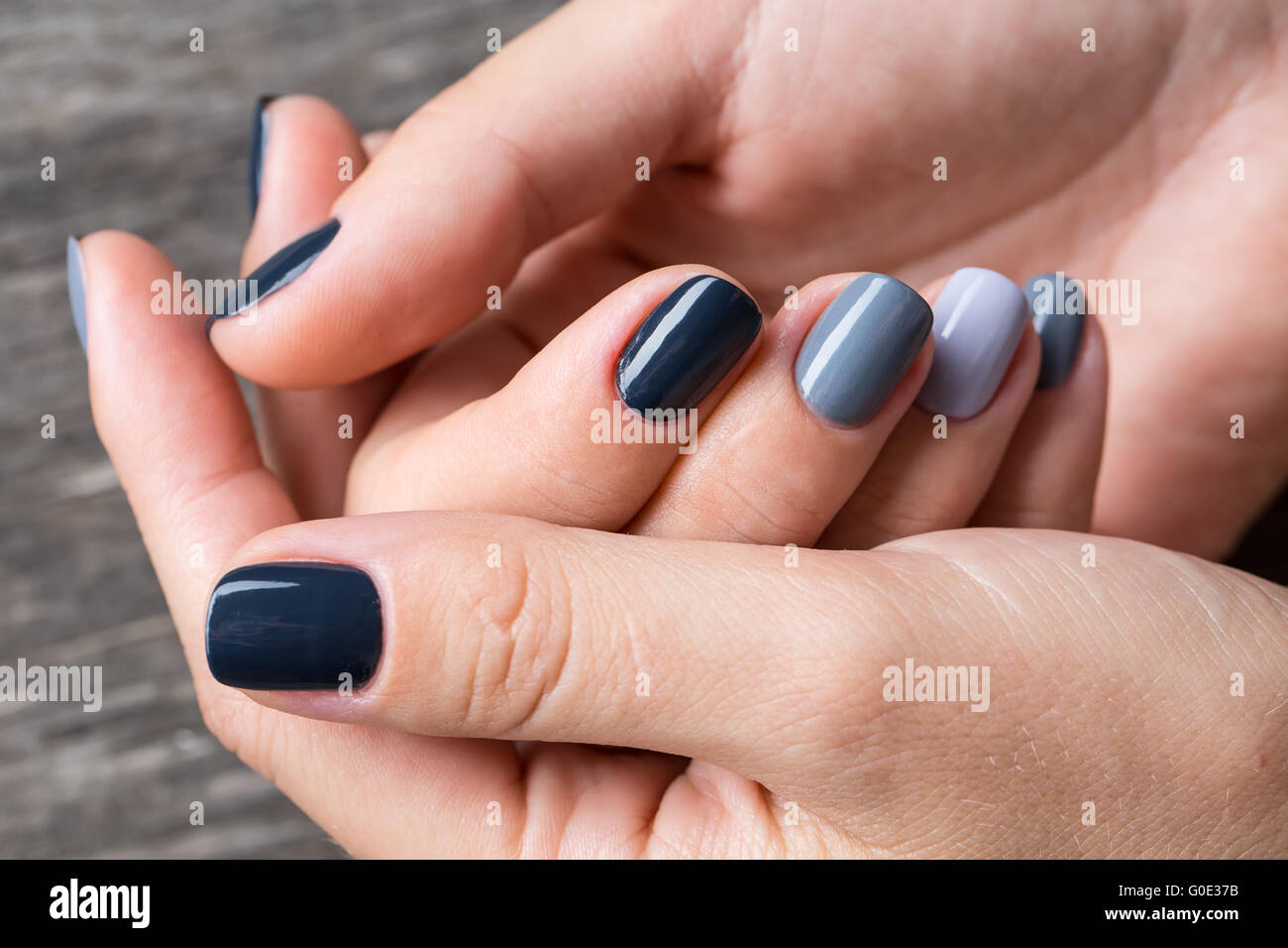 De belles mains avec la miniature peinte dans une couleur gris Banque D'Images