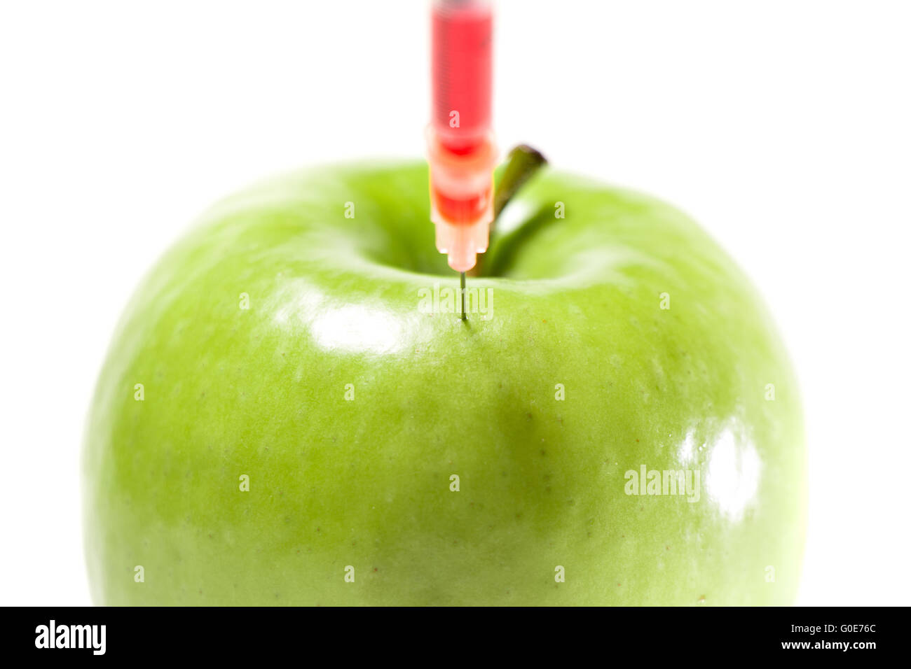 La pomme verte avec la seringue Banque D'Images