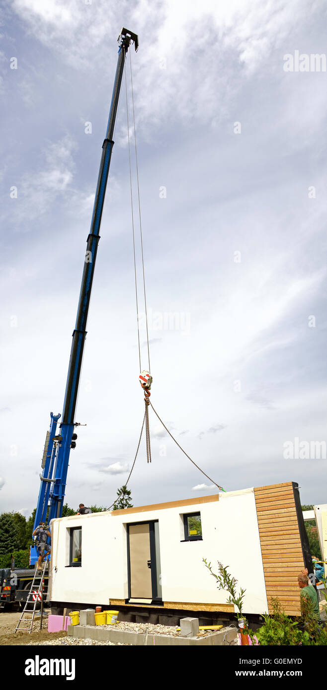 Mur d'une maison préfabriquée suspendu à une grue Banque D'Images