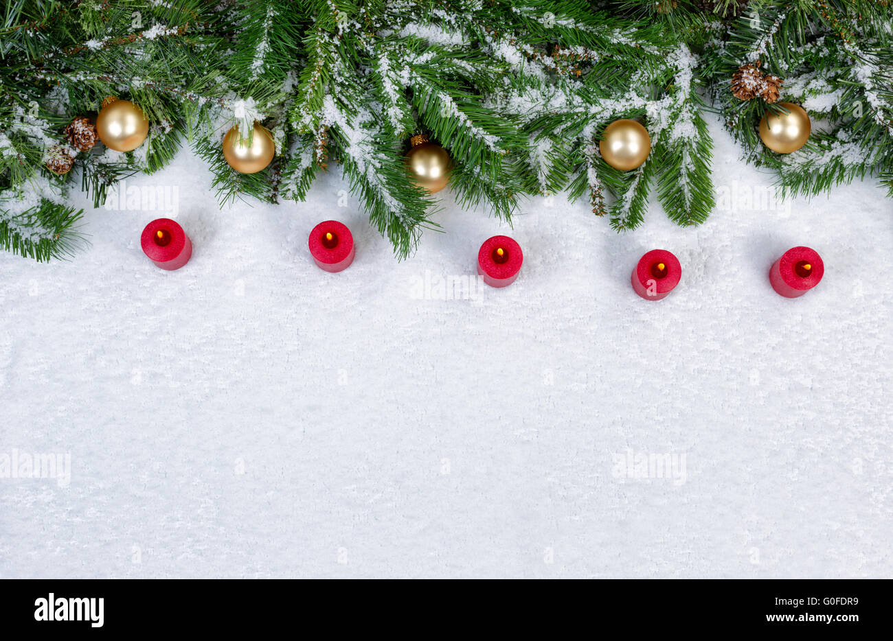 Brûler des bougies rouges et Noël objets couverts de neige fraîche Banque D'Images