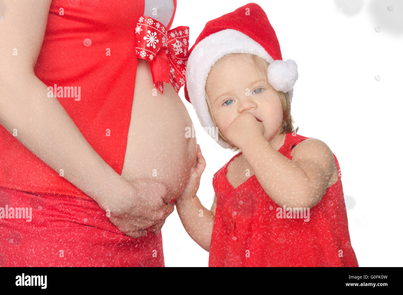 L'écoute de l'enfant ventre de femme enceinte, de Noël, des flocons de neige Banque D'Images