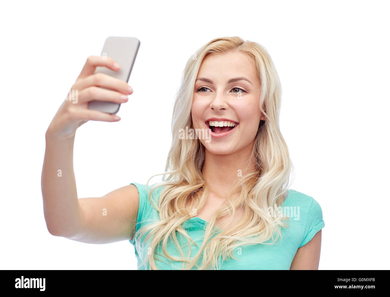 Smiling young woman with smartphone selfies Banque D'Images