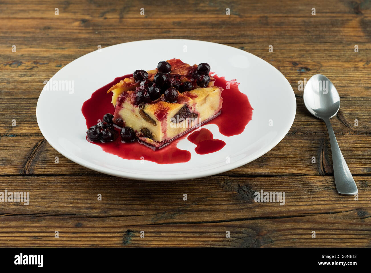 Pudding aux pruneaux, raisins secs sur le dessus d'une plaque blanche sur une table en bois Banque D'Images