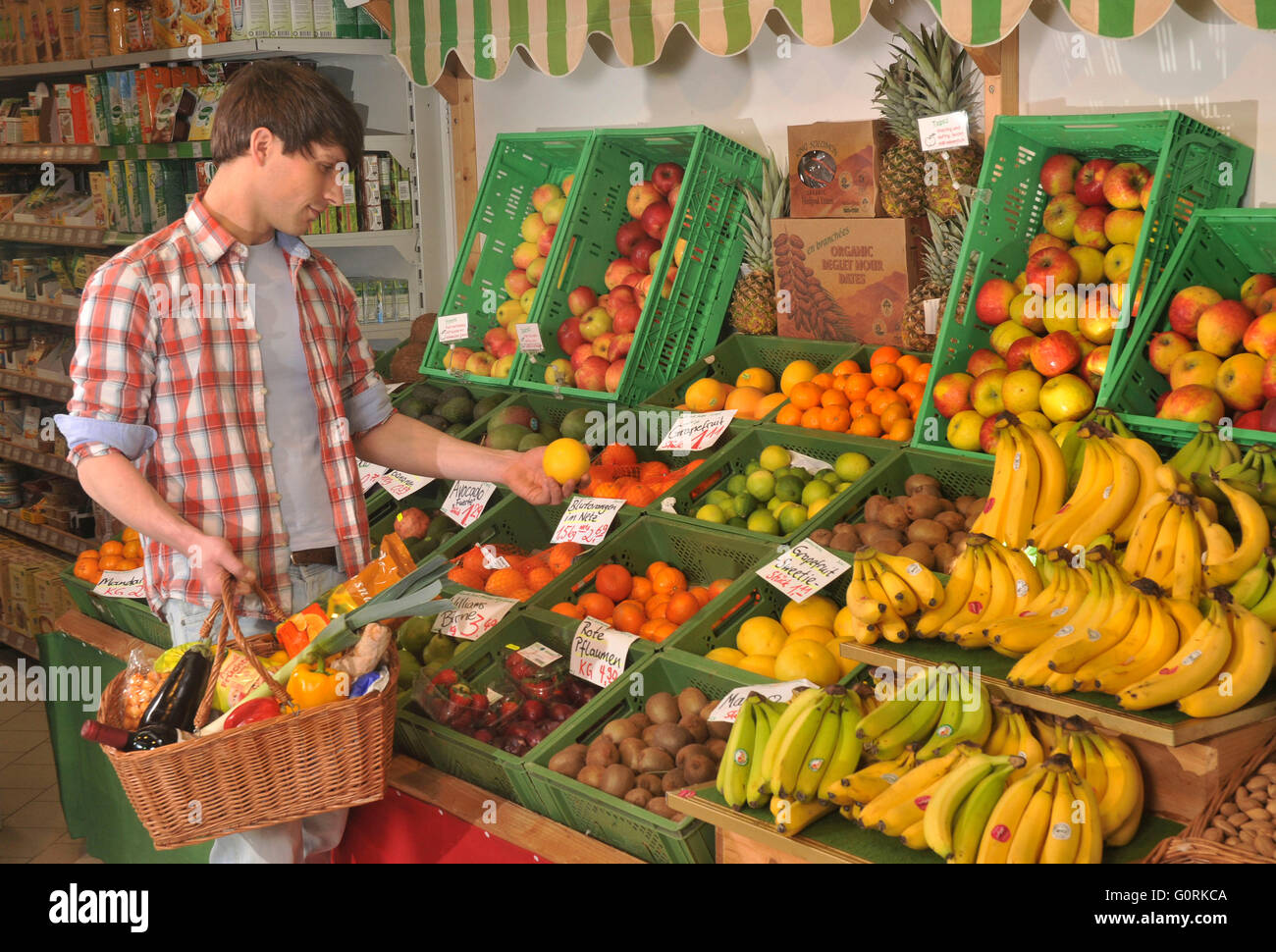 L'homme à la fruit rack, épicerie bio, magasin d'aliments végétariens, boutique, client, self-service, Berlin, Allemagne Banque D'Images