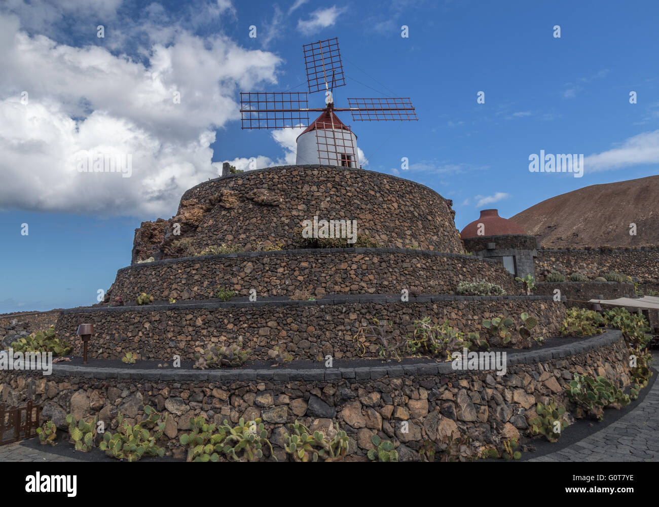 Moulin sur le dessus d'un chemin en spirale au jardin de cactus de Lanzarote. Conçue par César Manrique. Banque D'Images