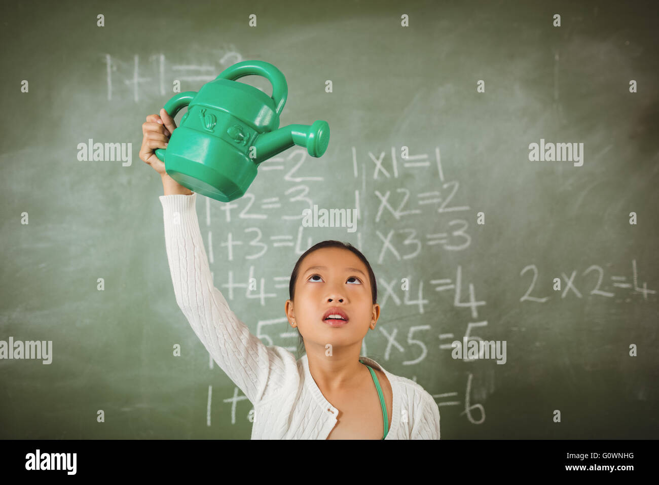 Lycéenne en utilisant un arrosoir Banque D'Images