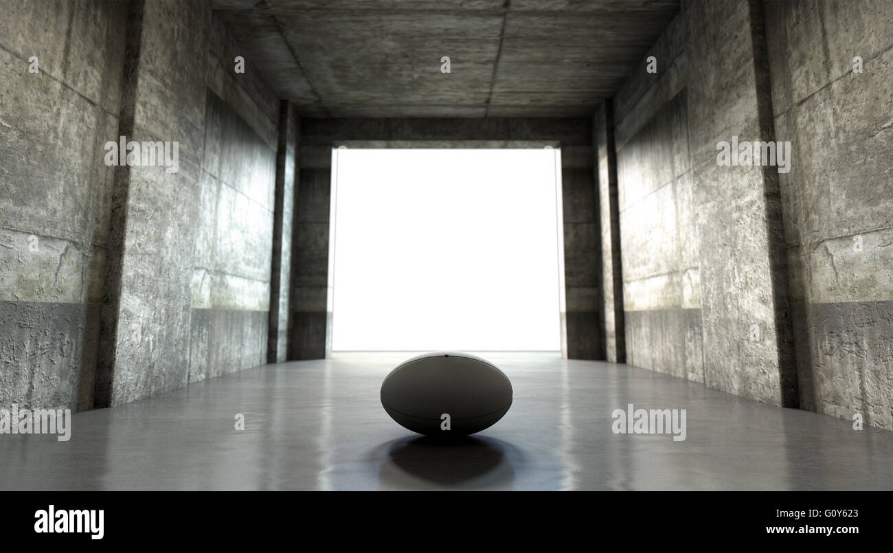 Un lointain regarder vers le bas un sombre tunnel du stade d'entrer dans une arène éclairée au loin avec un ballon de rugby placé à l'entrée Banque D'Images