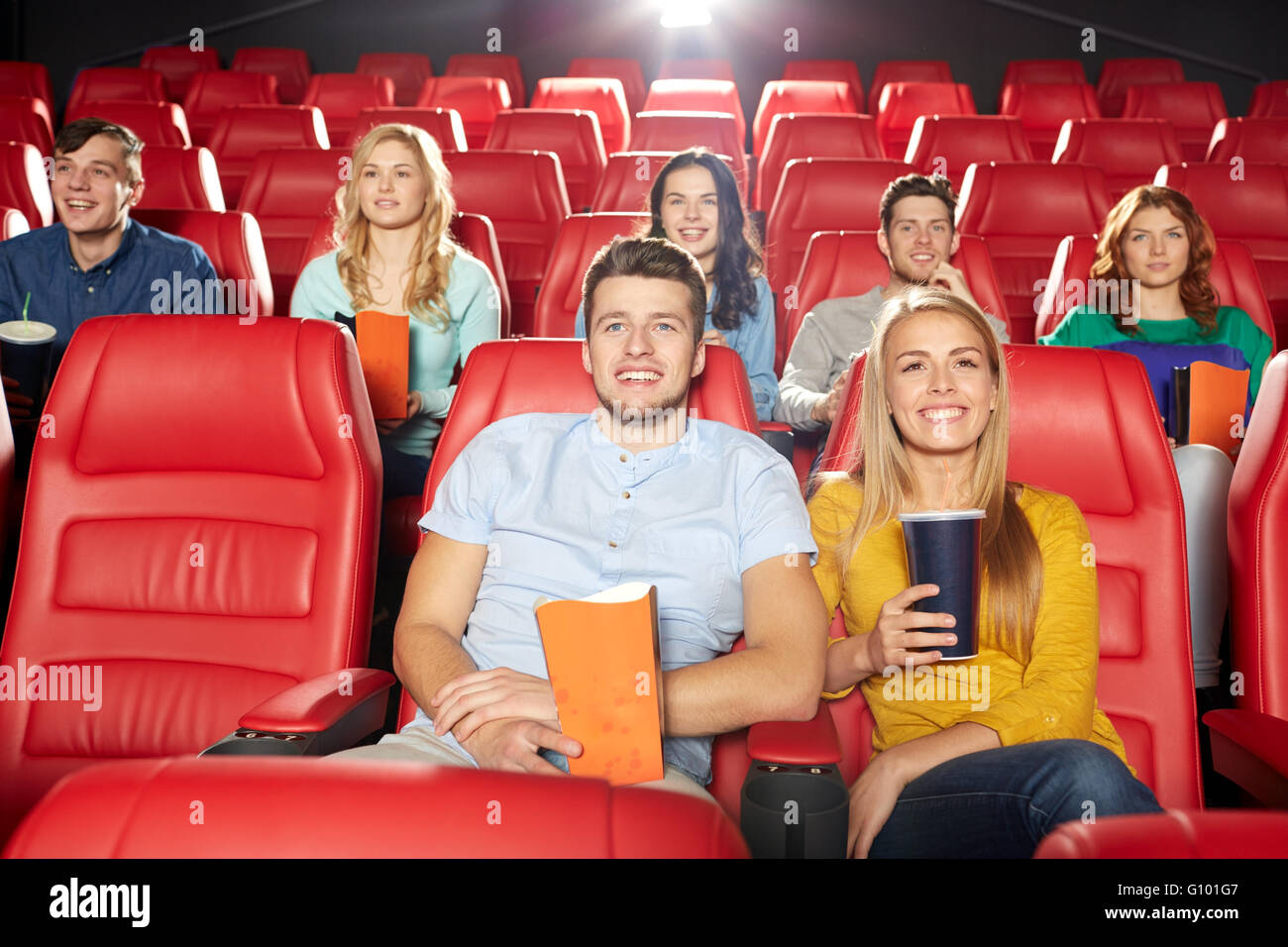 Happy friends watching movie in theatre Banque D'Images