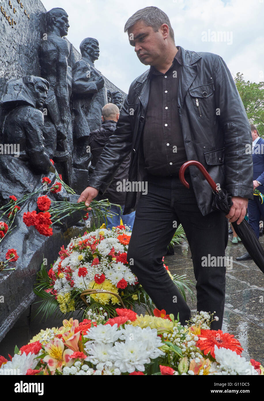 Kryvyï Rih, Ukraine - Mai 7, 2016 : l'Homme portant des fleurs à monument pendant l'événement consacré à 71th anniversaire de la victoire sur l'Allemagne nazie durant la Seconde Guerre mondiale, moment de commémoration et de réconciliation (Fête de la Victoire) Credit : Dmytro Aliokhin/Alamy Live News Banque D'Images