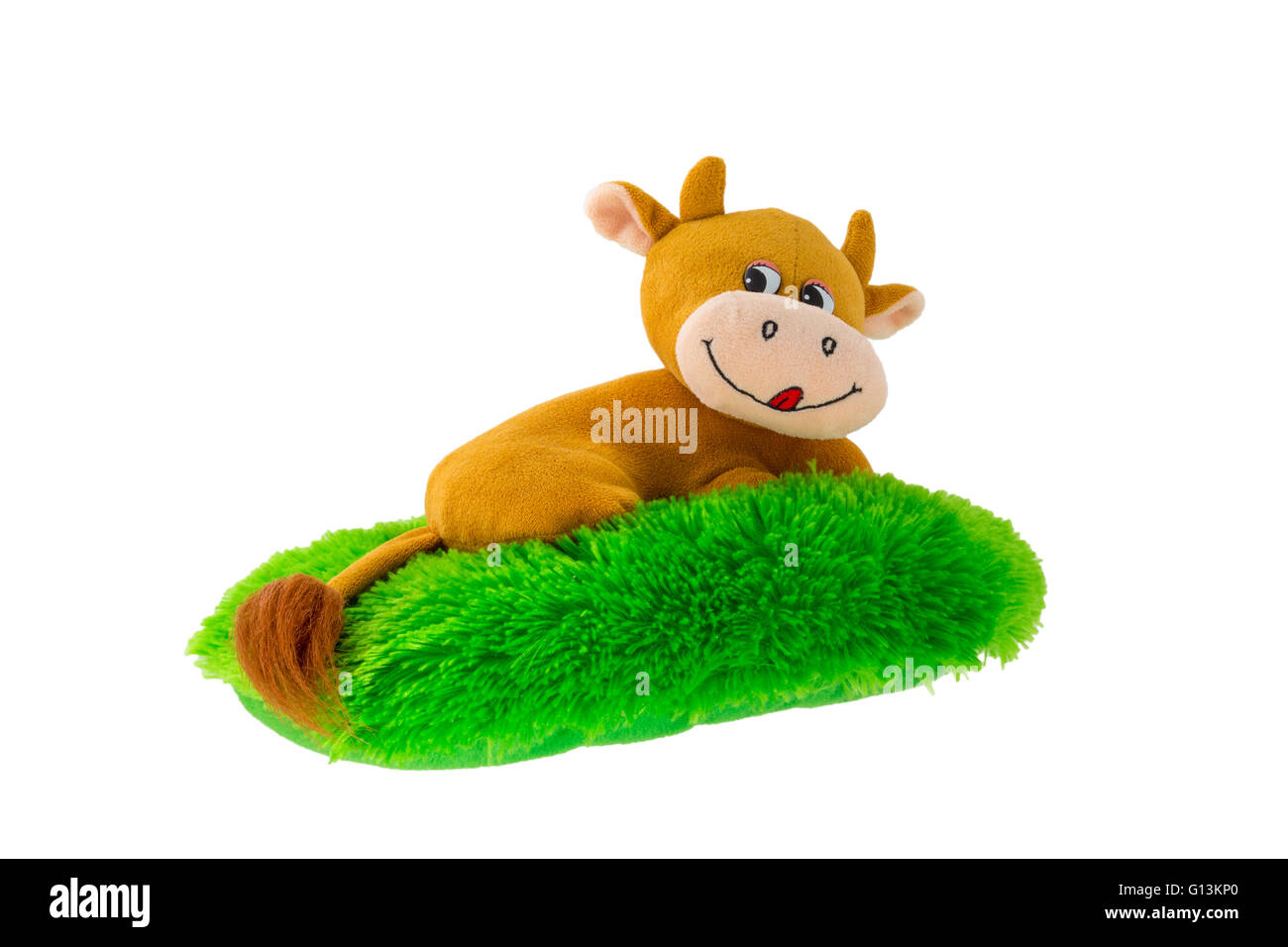 Peluche douce sous la forme d'un hippopotame allongé sur une pelouse verte Banque D'Images