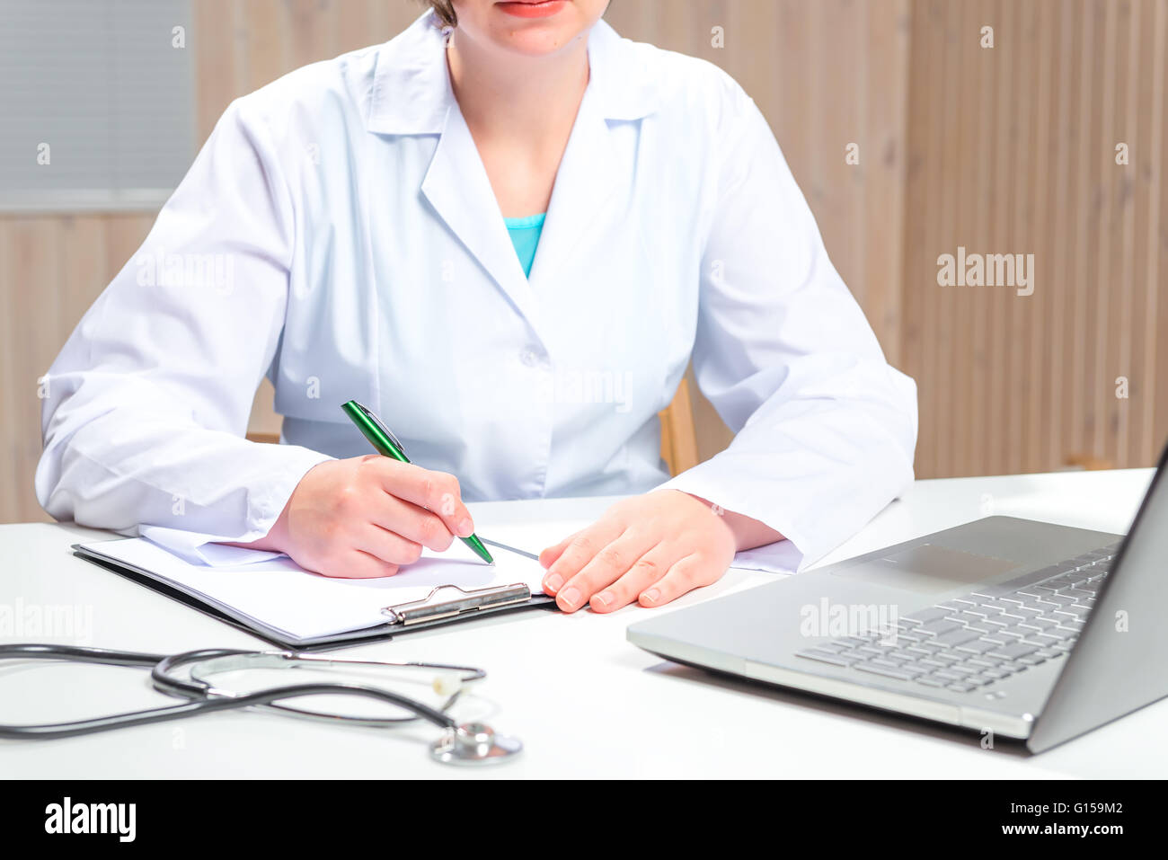 Femme en robe blanche un médecin travaillant à son bureau dans le bureau Banque D'Images