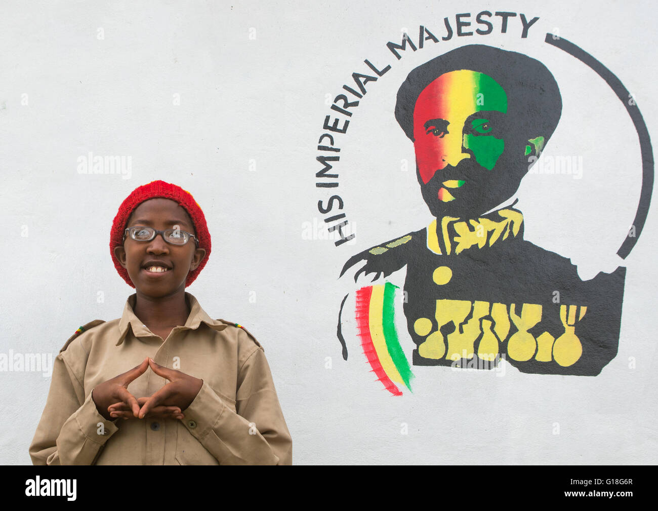 Rastafari fille appelée kizzy devant une peinture portrait Haile Selassie, Oromo, Shashamane, Ethiopie Banque D'Images