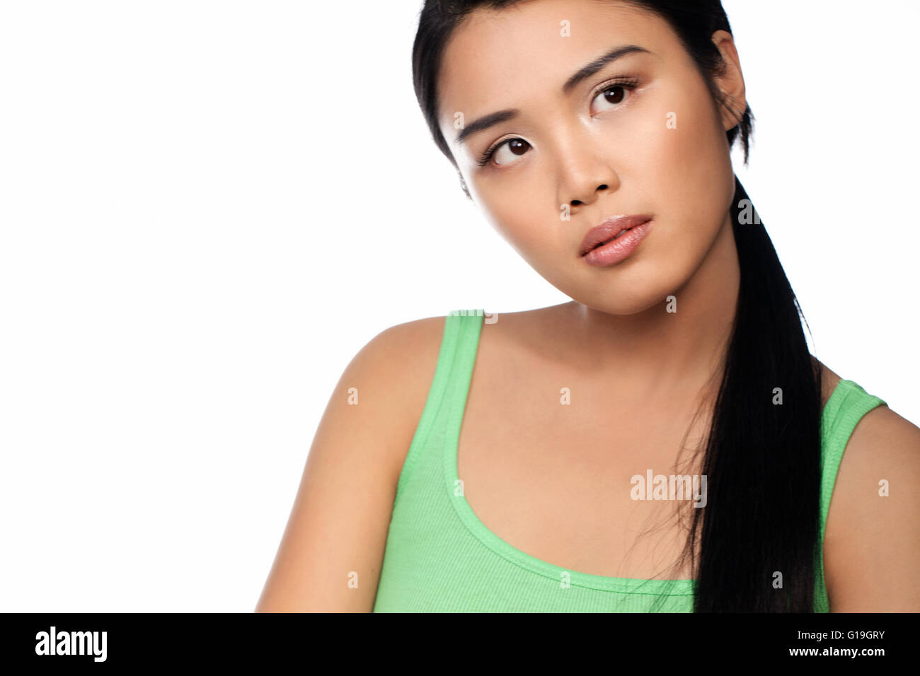 Cropped head and shoulders portrait of a young Asian woman isolated on white Banque D'Images