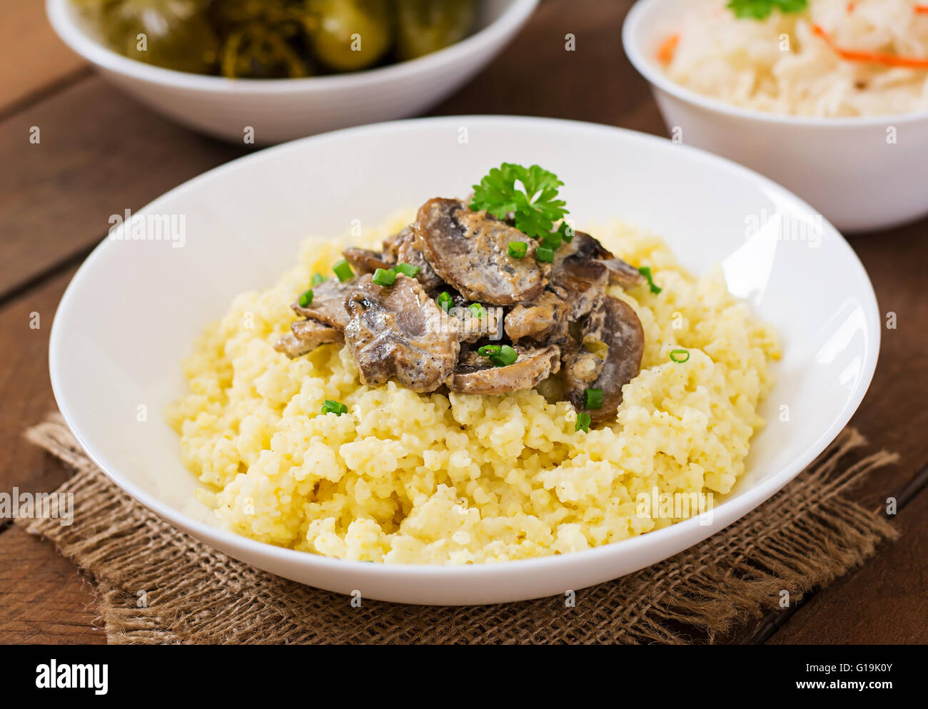Porridge de millet aux champignons dans un bol blanc Banque D'Images