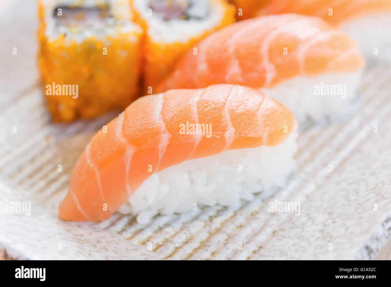 Sushis faits maison avec du saumon, du fromage à la crème Philadelphia, omelette Japonaise, concombre et wasabi. selective focus Banque D'Images