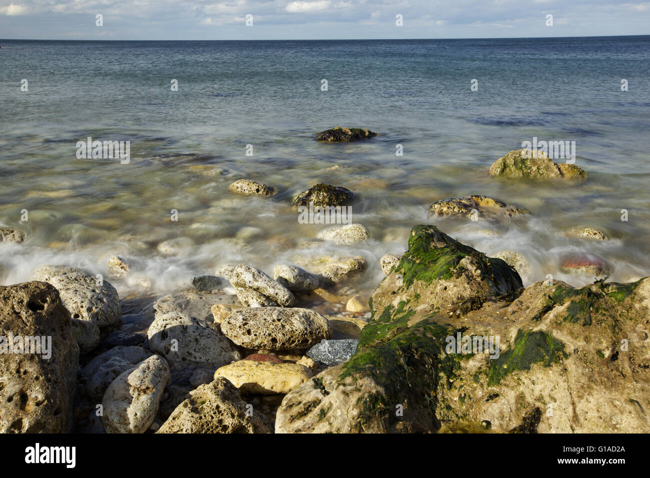 La côte de la mer avec des pierres, des vagues en slow motion Banque D'Images