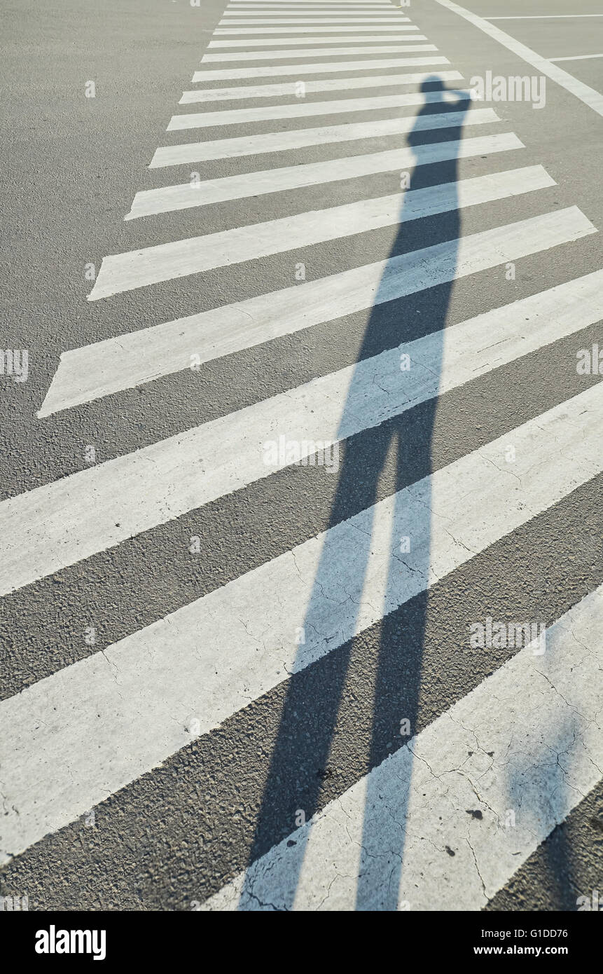 Photographie d'un grand ombre de photographe sur un passage piéton Banque D'Images