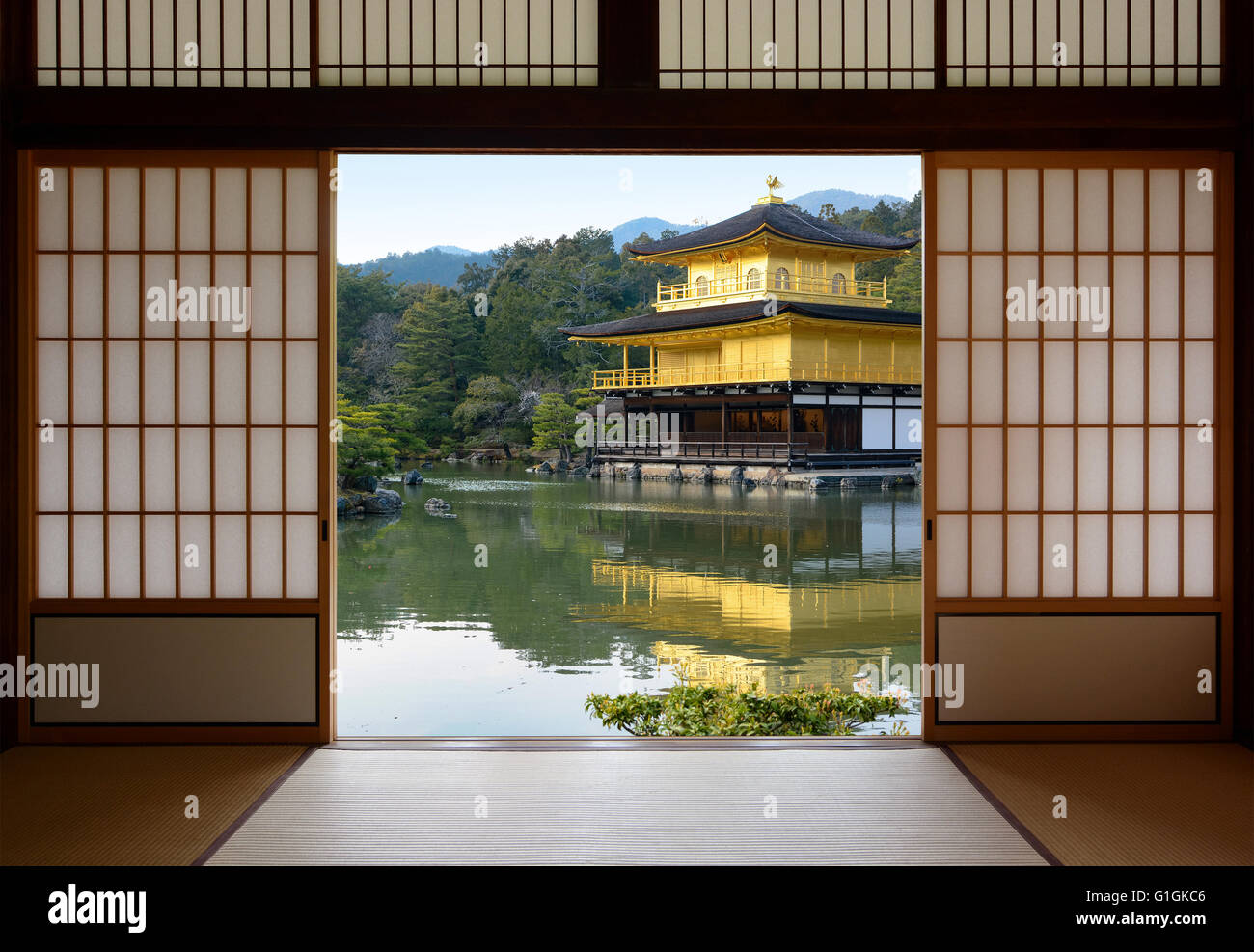 Vue d'une belle japonaise temple doré et étang jardin vu à travers les portes de papier de riz Banque D'Images