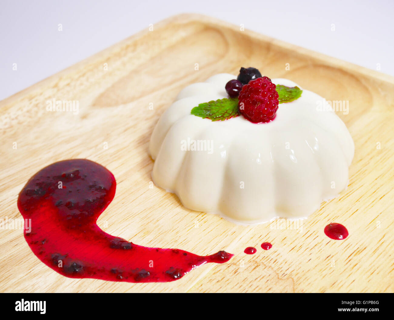 Le panna cotta avec un mélange de sauce aux baies Banque D'Images