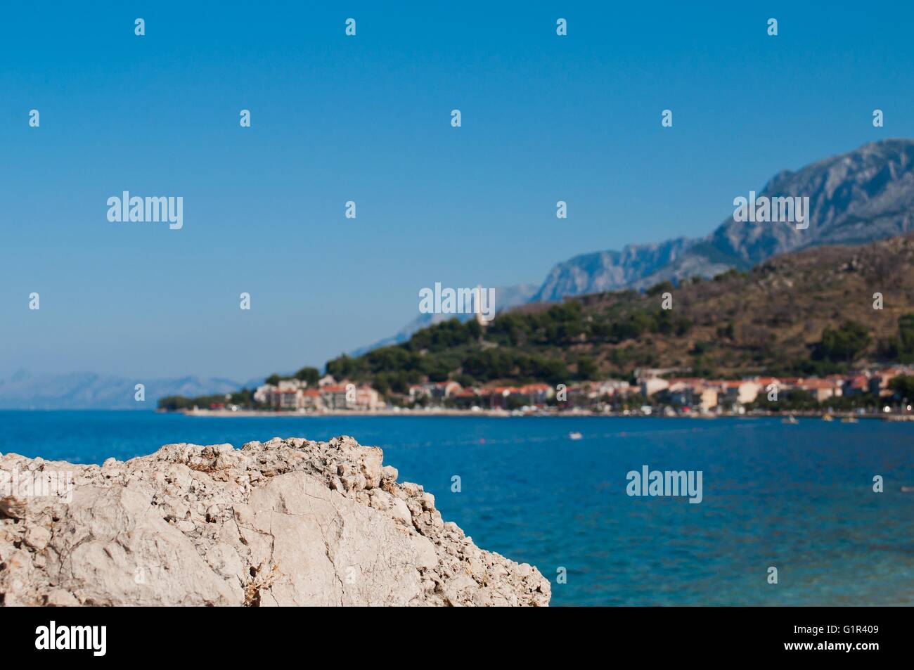 Mer Adriatique à Podgora en Croatie avec Seagull monument's wings et montagne BIOKOVO en arrière-plan. L'accent sur le rocher en face. Banque D'Images