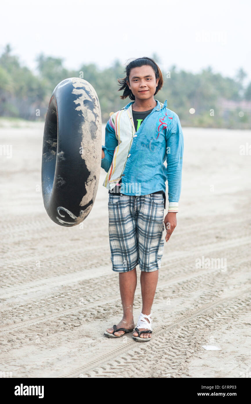 Portrait d'un jeune homme qui travaille avec des touristes sur une plage, dans la station de Ngwe Saung au Myanmar. Banque D'Images