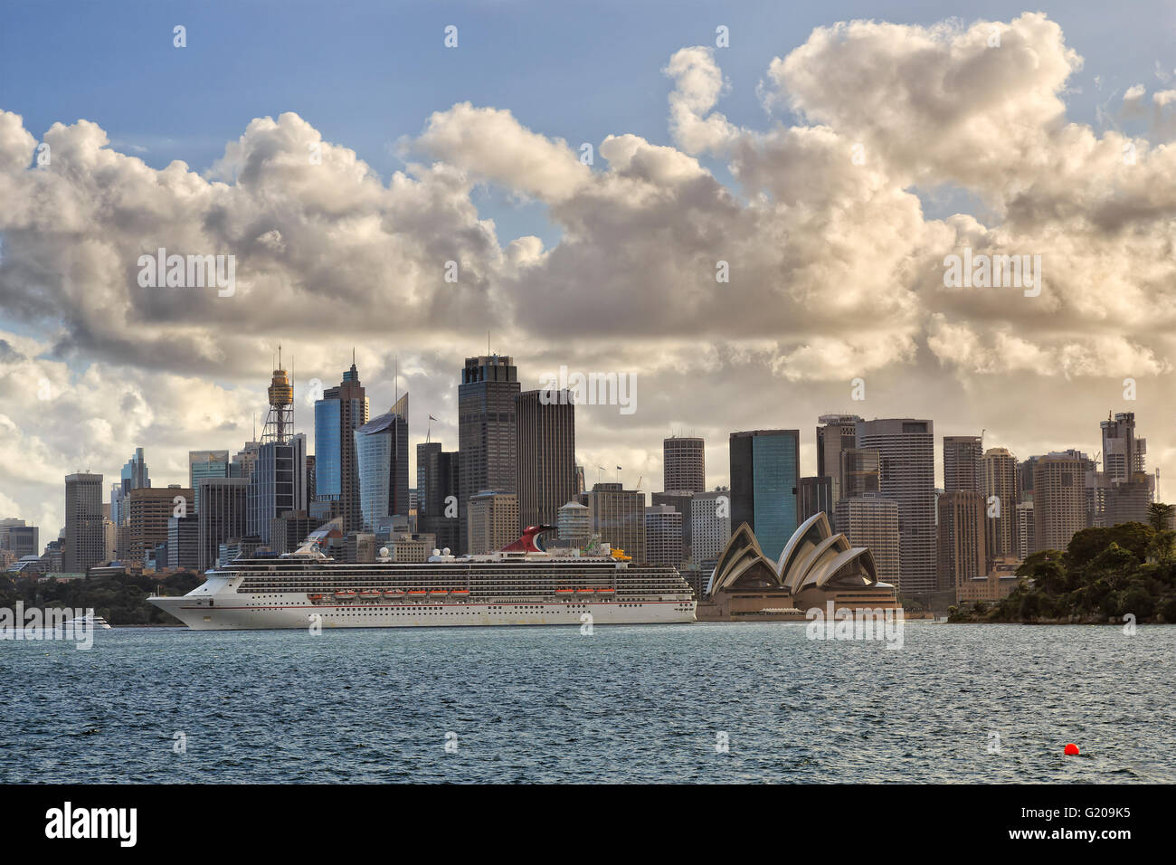 Énorme navire de ligne de quitter le port de Sydney et des gares de voyageurs d'outre-mer en passant par les gratte-ciel de la CDB, des tours et des bureaux. Banque D'Images