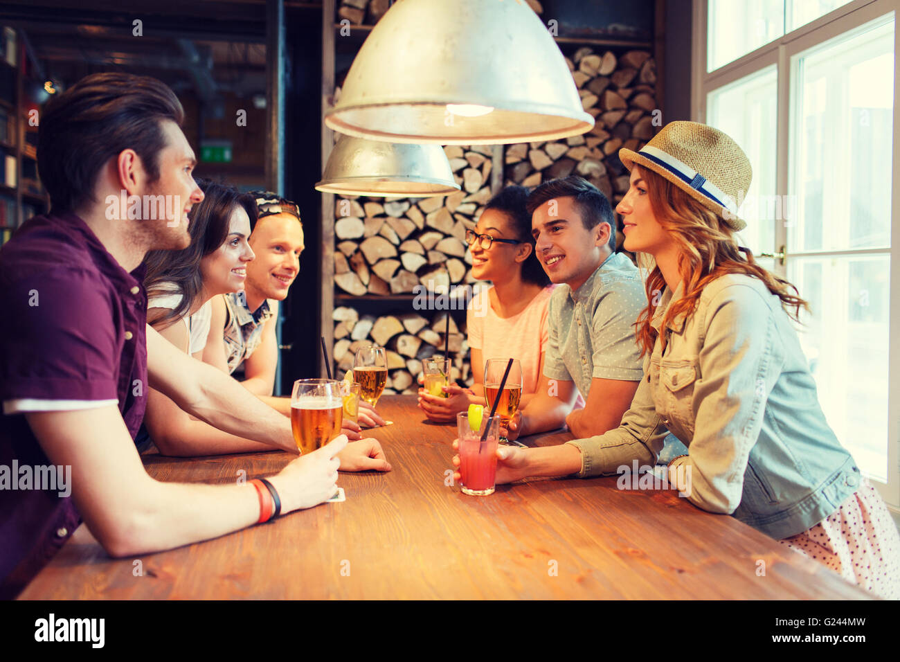 Happy friends avec un verre au bar ou au pub parle Banque D'Images