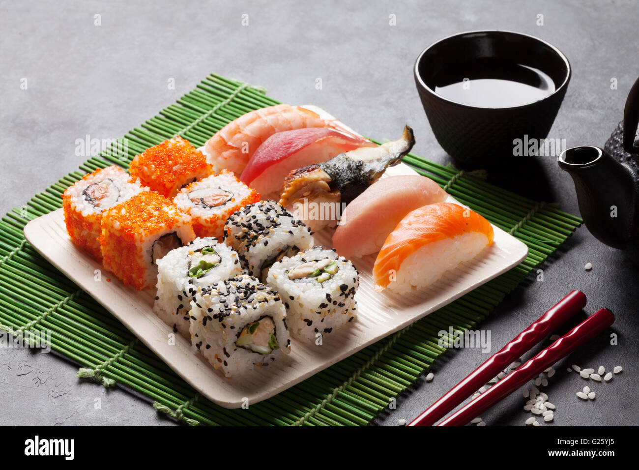 Ensemble de sushi, maki et thé vert sur table en pierre Banque D'Images