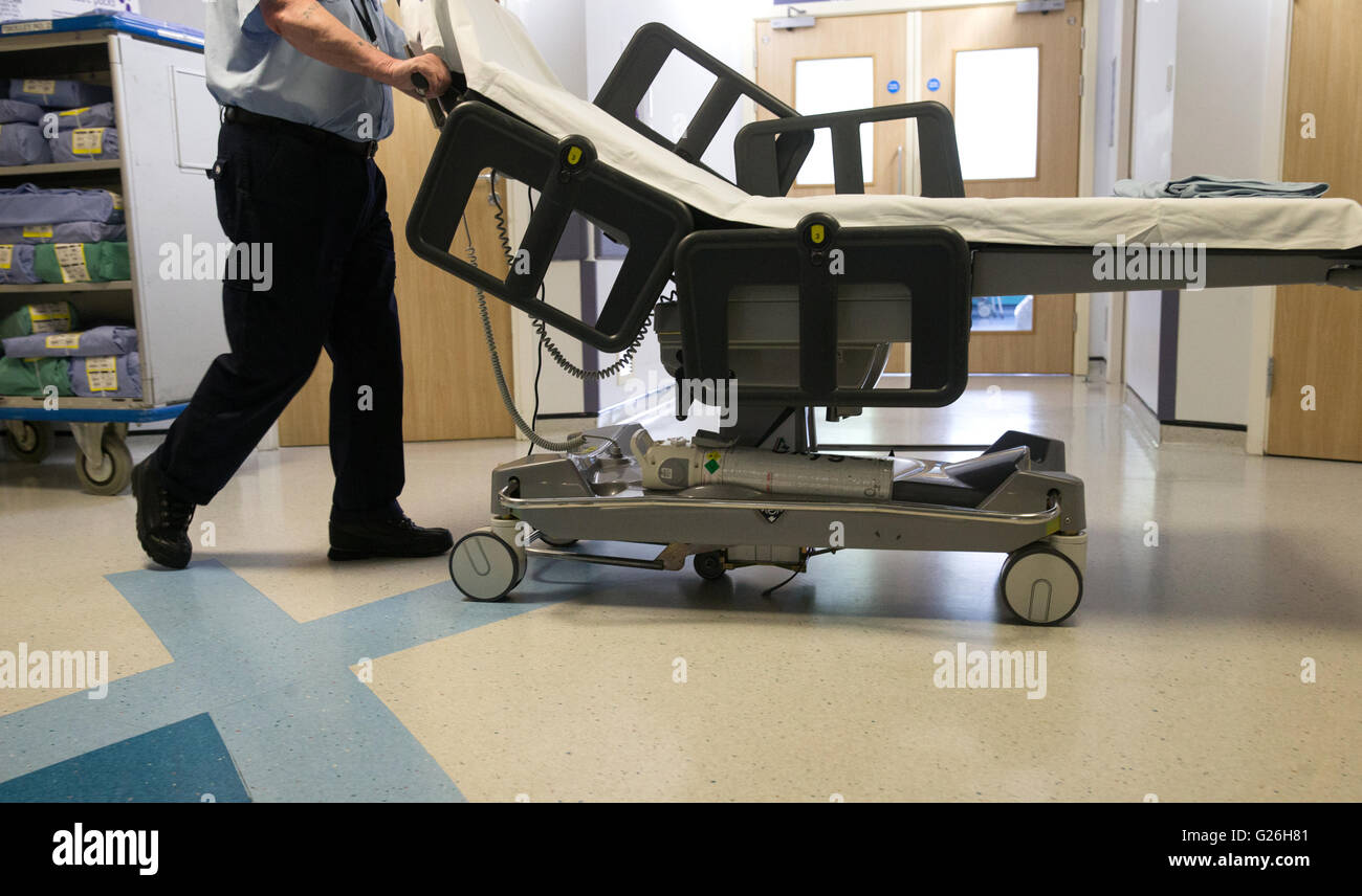 Un portier pousse un chariot dans un couloir de l'hôpital Banque D'Images