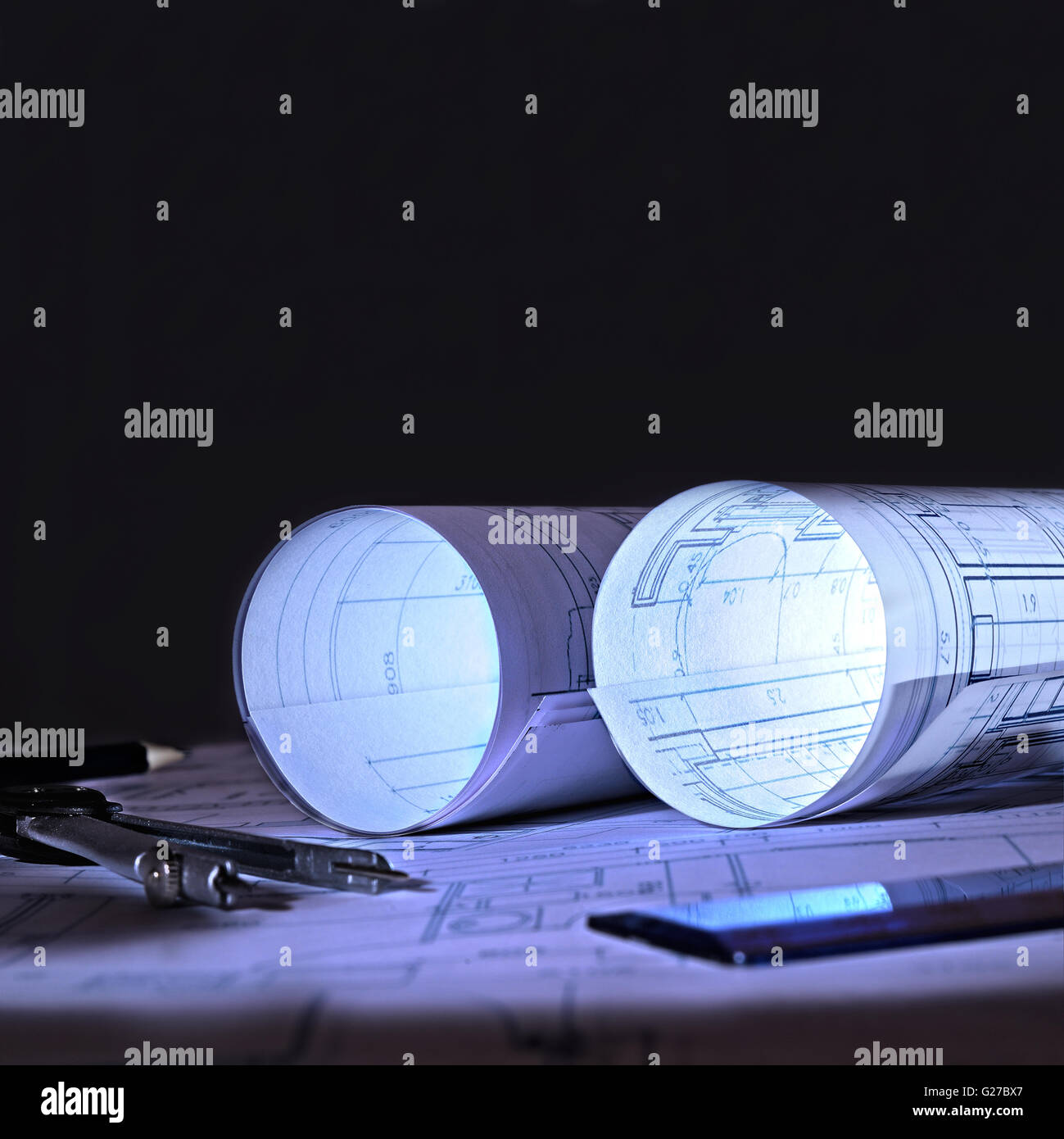 Plans architecturaux sur une table d'un bureau à l'aube Banque D'Images