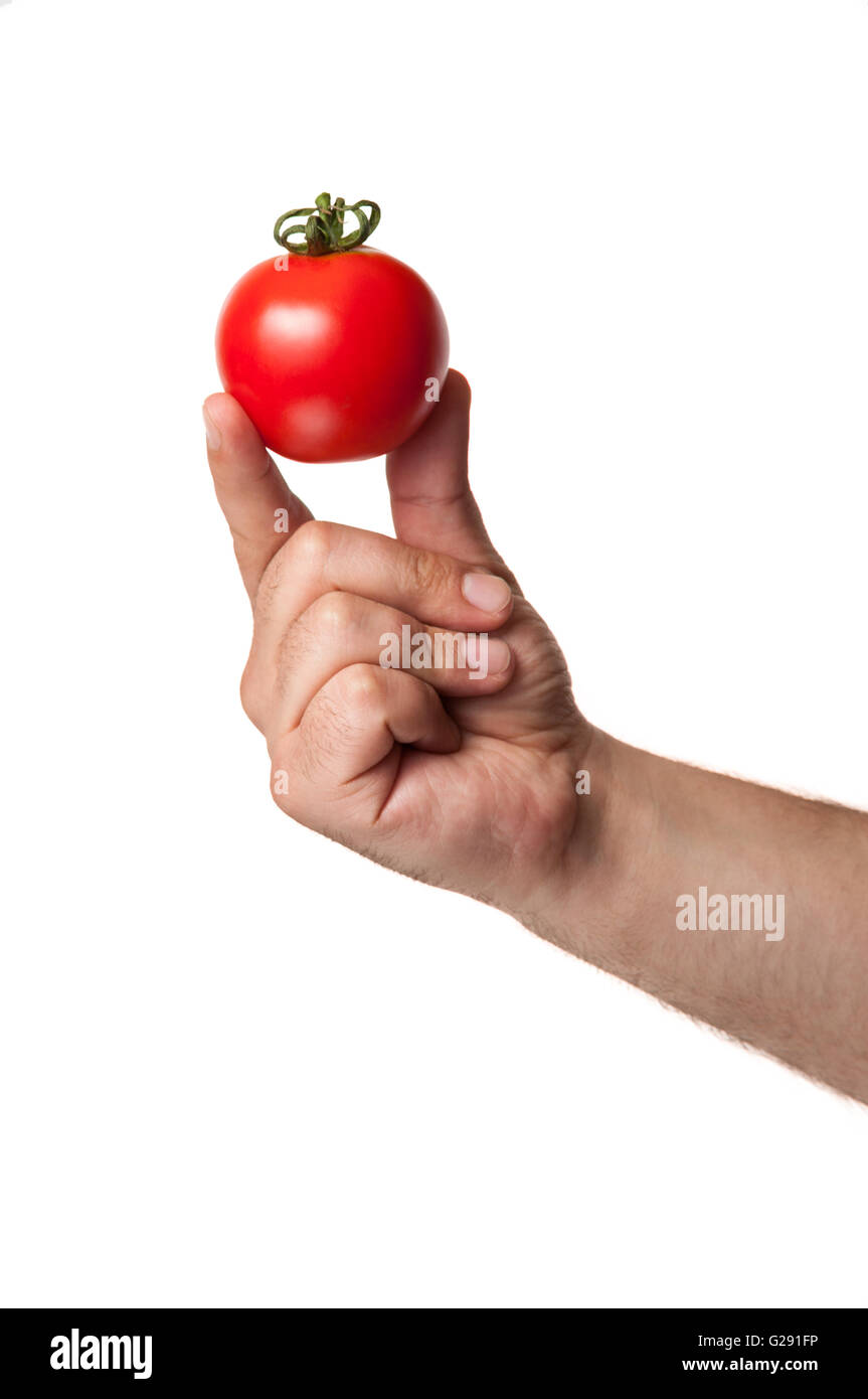 Une tomate rouge parfaite tenue par 2 doigts isolé sur fond blanc Banque D'Images