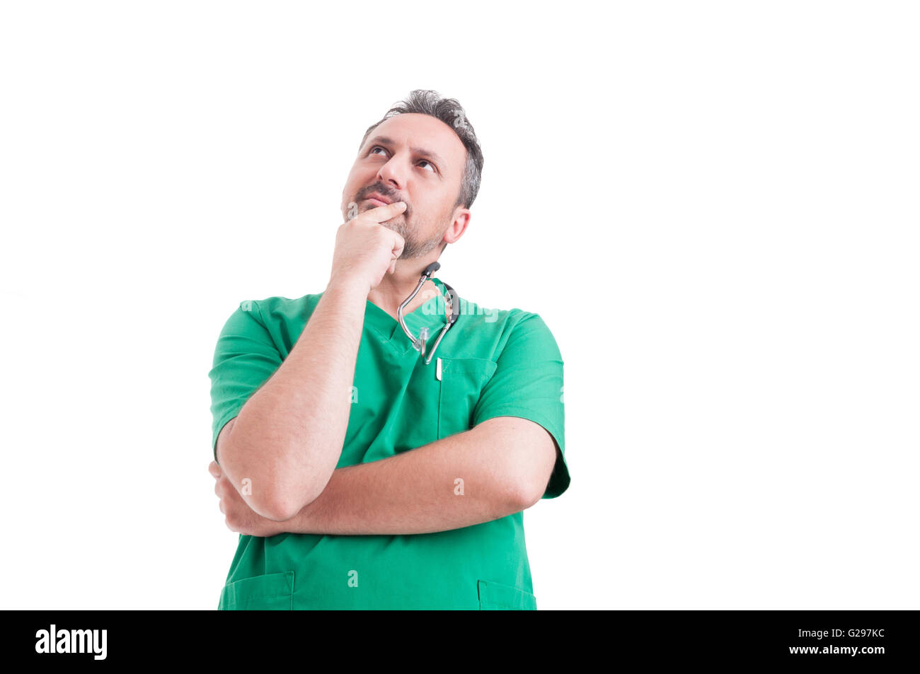 Le médecin et pensif wearing green scrubs with stethoscope Banque D'Images
