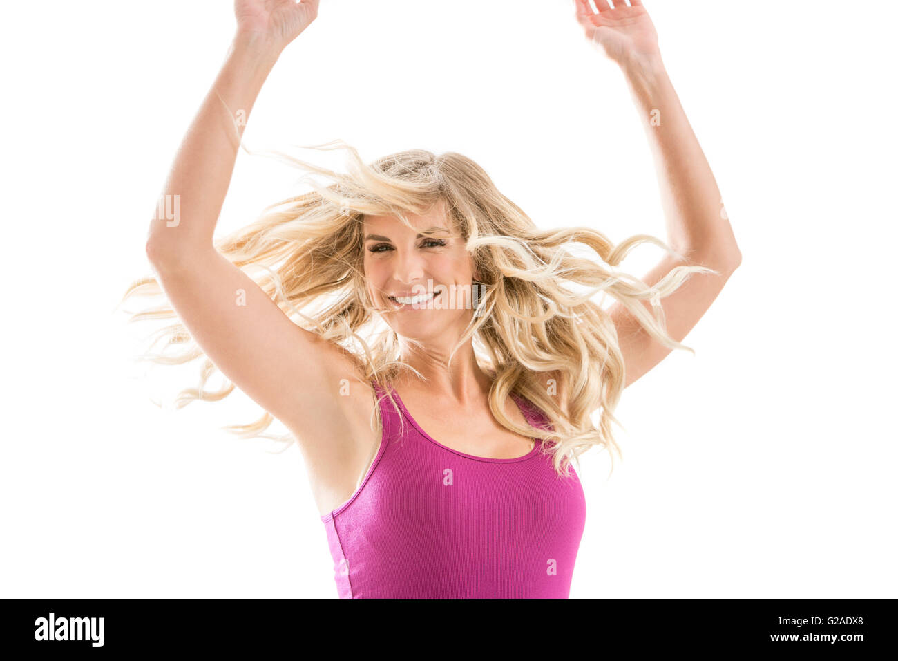 Smiling blonde woman dancing Banque D'Images
