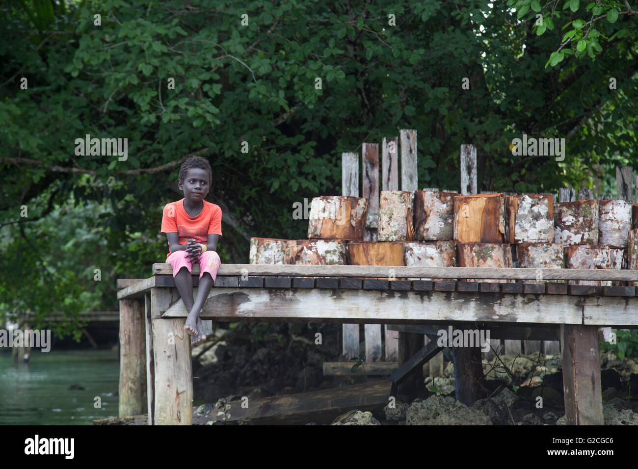 Seghe, Îles Salomon - 16 juin 2015 : Local boy sitting on a pier Banque D'Images