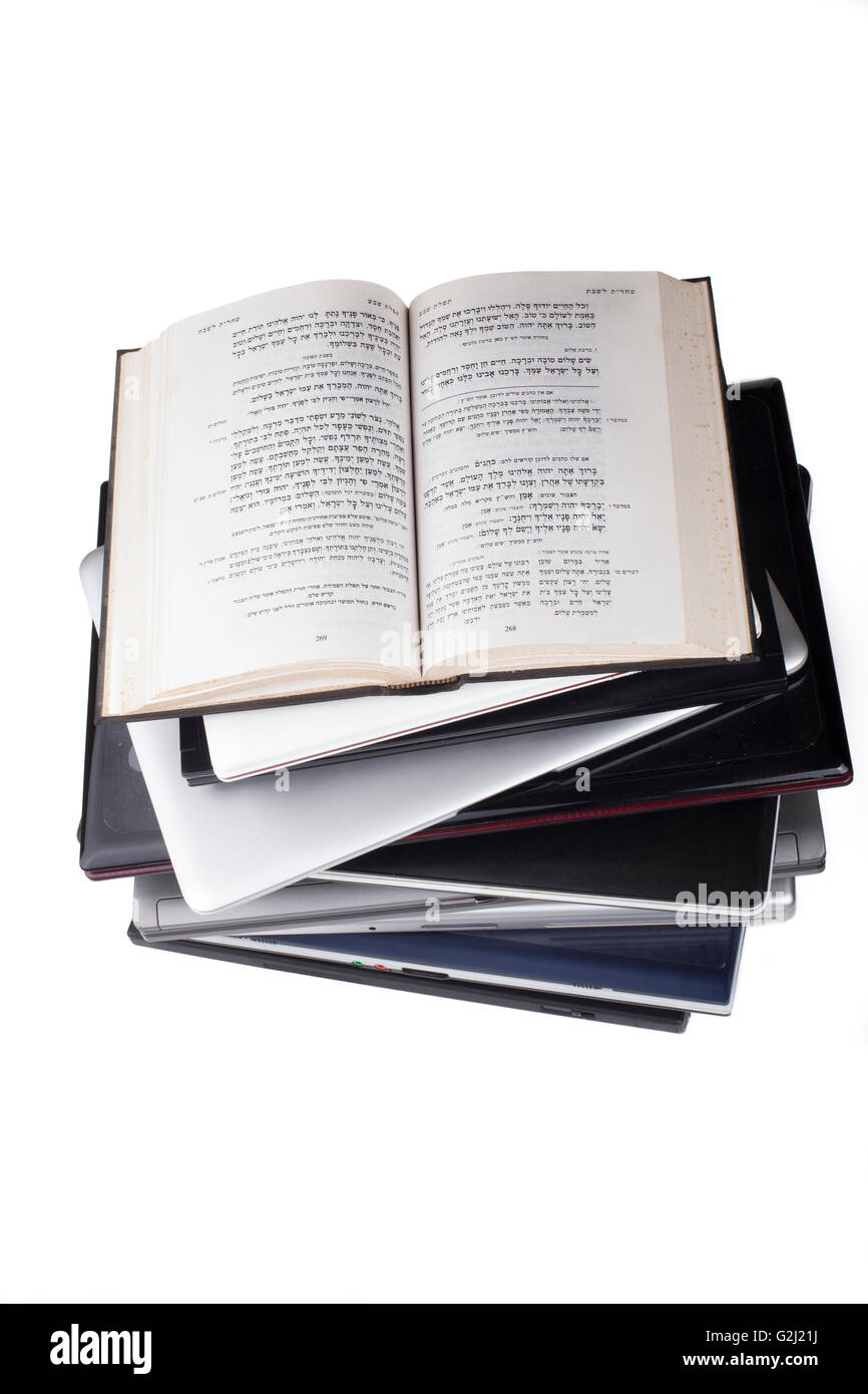 Vieille Bible en hébreu sur le dessus de la pile d'ordinateur portable top view isolé sur fond blanc Banque D'Images