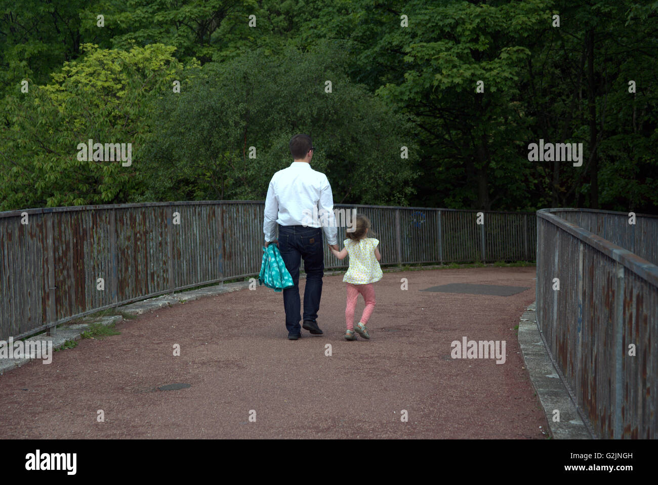 Père et fille walking on path Glasgow, Écosse, Royaume-Uni. Banque D'Images