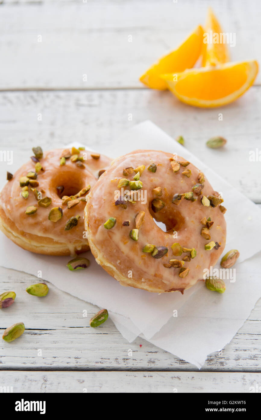 Donuts avec glaçage Orange et pistaches Banque D'Images